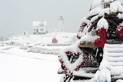 Nubble Light During Snowstorm With Holiday Lobster Trap Tree